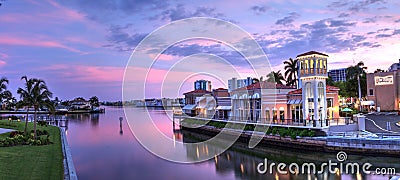 Sunset over the colorful shops of the Village on Venetian Bay Editorial Stock Photo